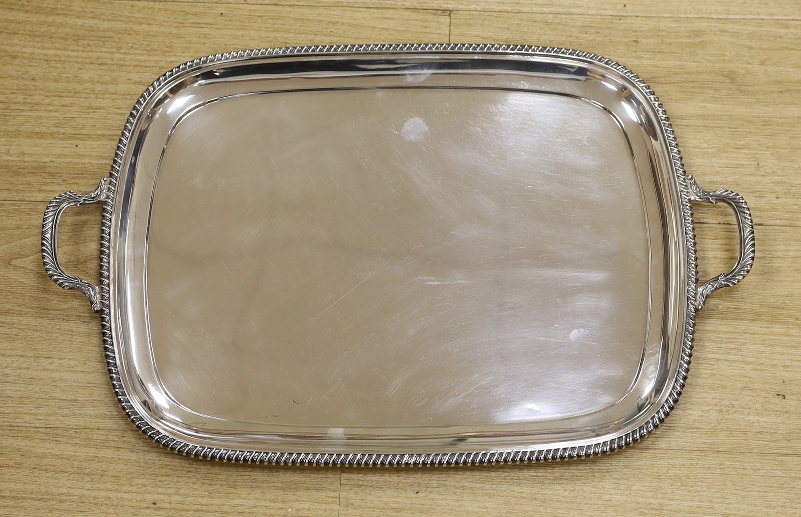 A George VI silver two handled rectangular tea tray, with gadrooned border, George Howson, Sheffield, 1937, 53.2cm, 58.5oz.
